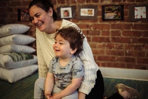 Ariel laughing with one of her Roots students