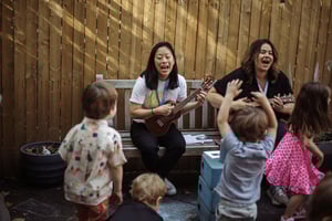 Benna and Michelle leading a sing-along in the backyard