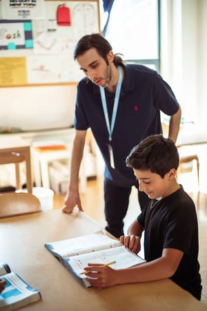 Corlears teacher Josh helps a student with their work