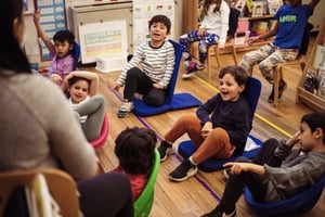 Kindergarten students participating in class