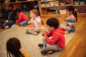 PreK in Spanish class on the rug