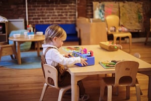 Roots student sitting at a table