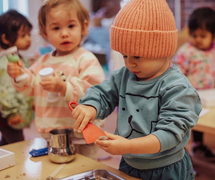 Roots students playing with magnatiles