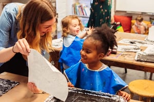 Studio art teacher Sara with a Seedlings Yellow student