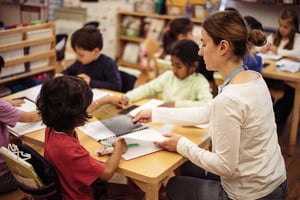 Teacher working with students in kindergarten