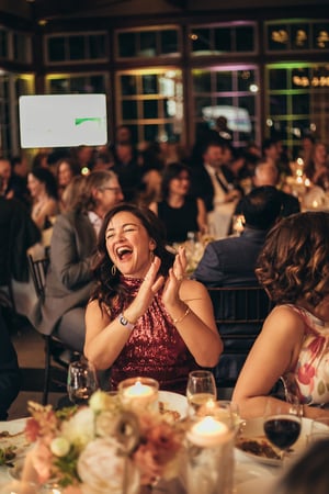 woman at Corlears gala clapping